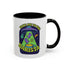 White ceramic coffee mug with a bright yellow handle and interior, featuring a printed alien abduction design with two purple cats, peace signs, and the phrase “Take Me to Your Barista” in green and purple text.